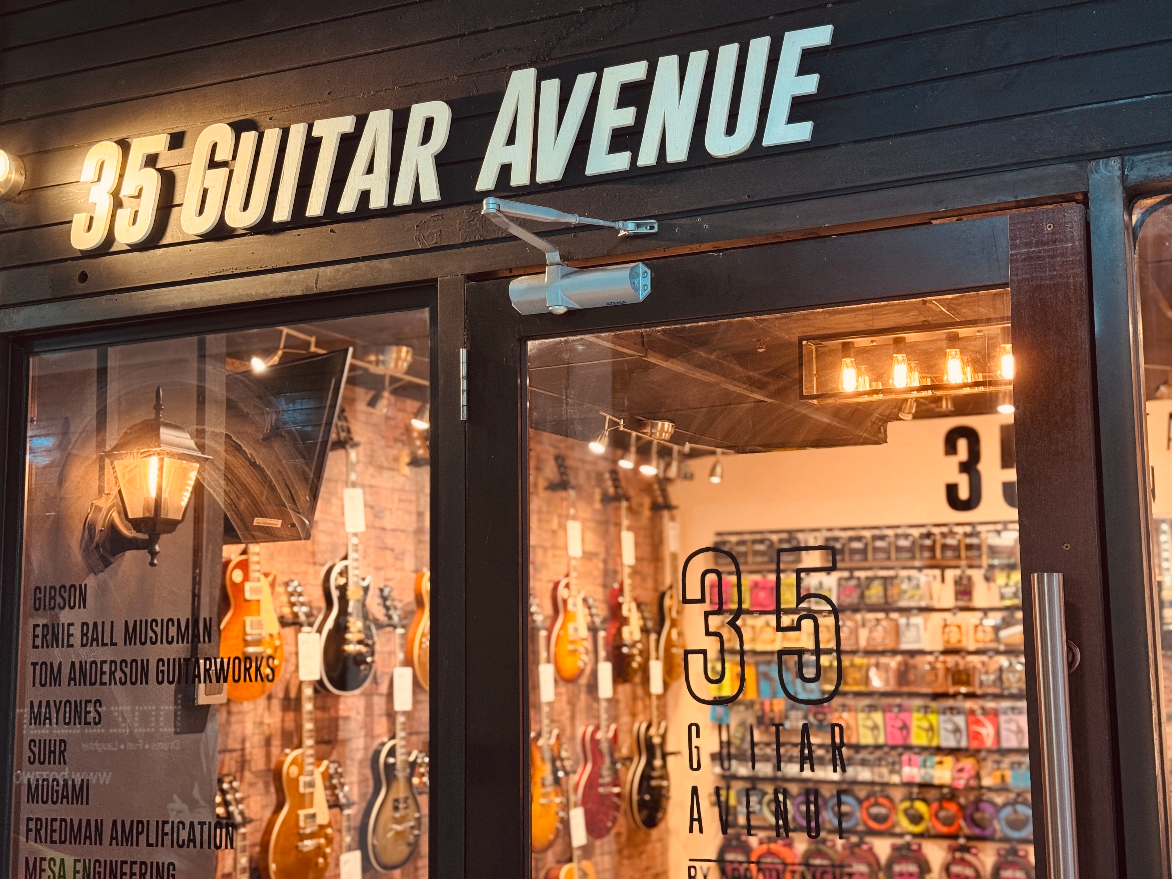 Storefront of 35 Guitar Avenue with guitar display inside